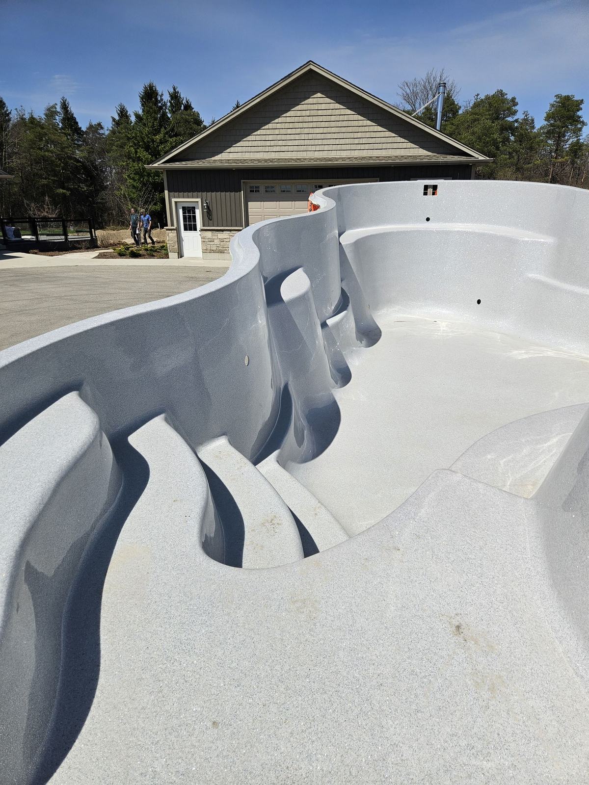 Close-up of the moulded steps and bench in a new fibreglass pool shell
